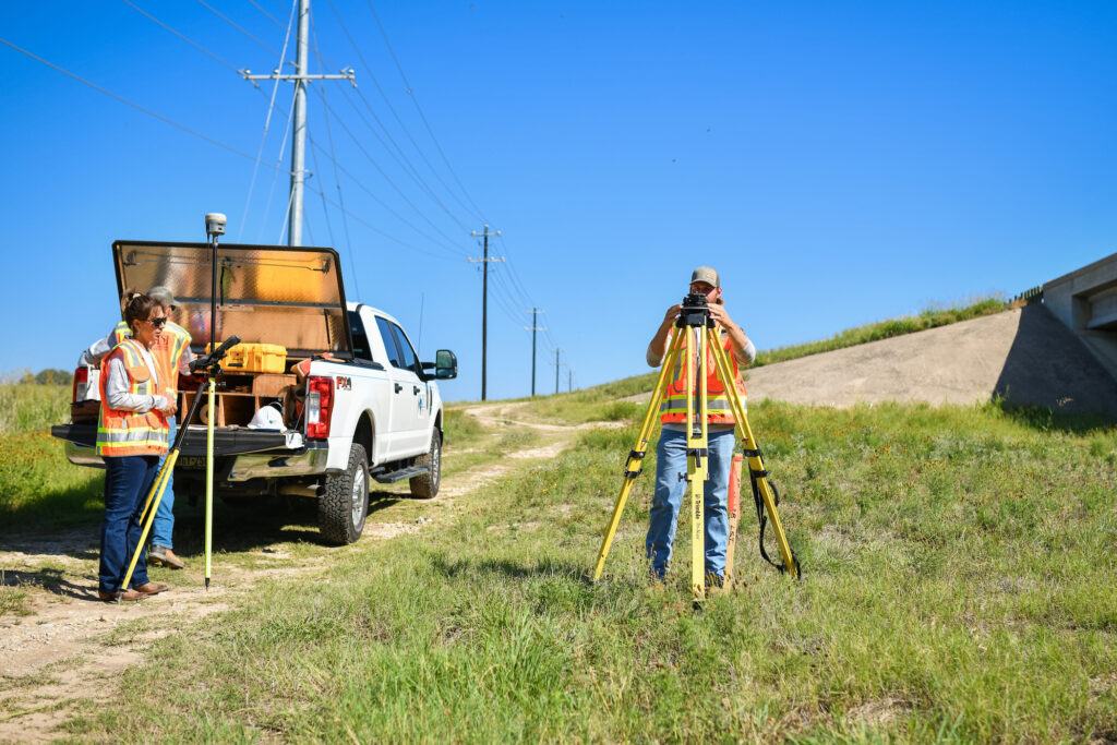 land survey technicians and drone pilots prep area for land survey