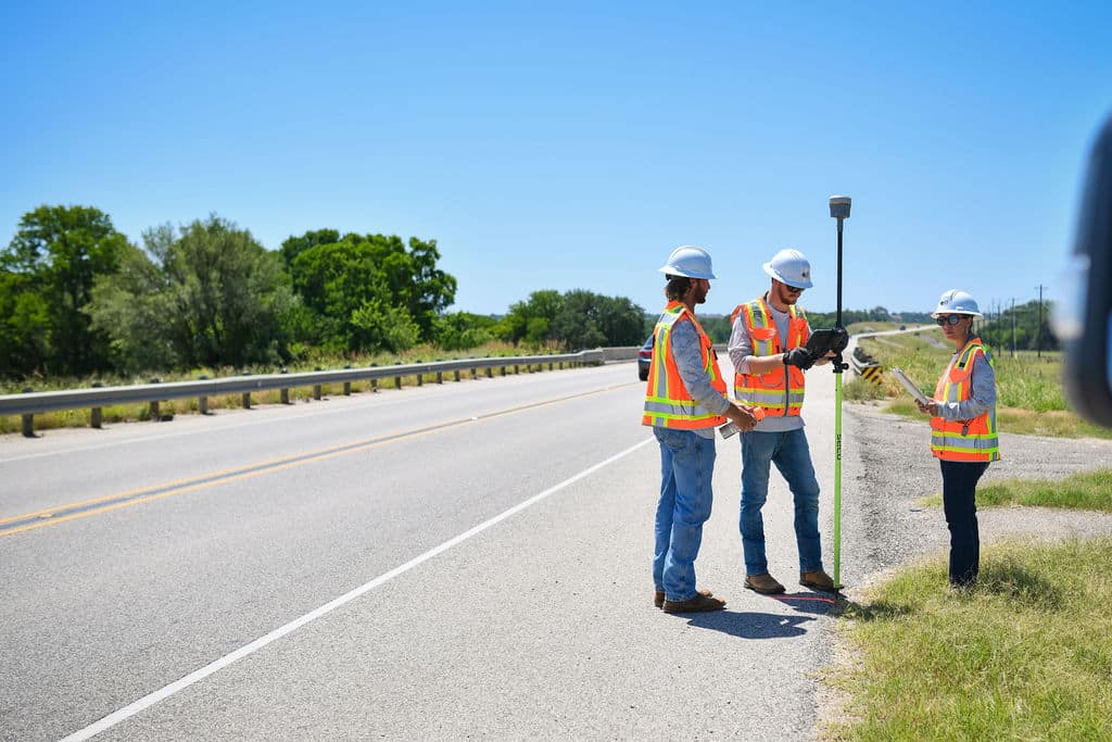 land survey technicians on highway in central Texas