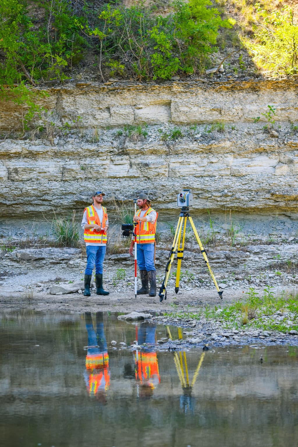 Land surveyors prepare geospatial services tool, Total Robotic Station, for bridge and highway survey
