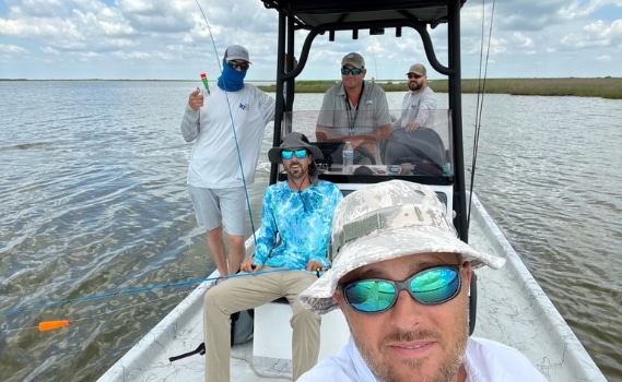 Five team members of Landesign Services, Inc. enjoy a day away on a fishing boat